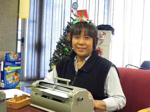 A woman dressed up for christmas at Braille class